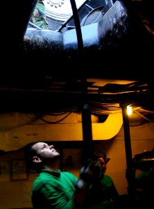 US Navy 111022-N-VD490-012 Aviation Boatswain's Mate (Equipment) 3rd Class Dustin Woodruff, from Dallas, stands by to stow the barricade webbing as