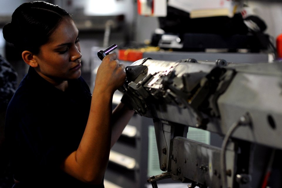 US Navy 111020-N-XE109-064 Aviation Ordnanceman Airman Melissa Madrid performs maintenance on a bomb rack aboard the aircraft carrier USS George H