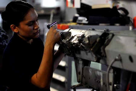 US Navy 111020-N-XE109-064 Aviation Ordnanceman Airman Melissa Madrid performs maintenance on a bomb rack aboard the aircraft carrier USS George H