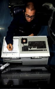US Navy 111025-N-OY799-046 Air Traffic Controller Airman Juan Mireles, from Corpus Christi, Texas, records incoming aircraft in the carrier air tra