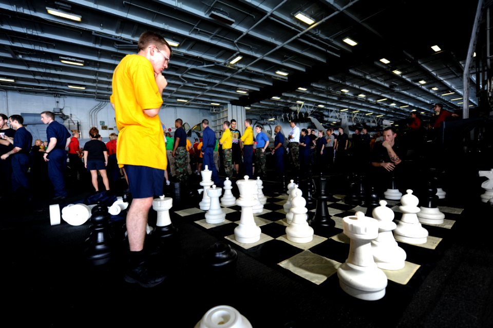 US Navy 111022-N-OY799-095 Sailors play a large-scale chess game in hangar bay two during a steel beach picnic aboard the Nimitz-class aircraft car