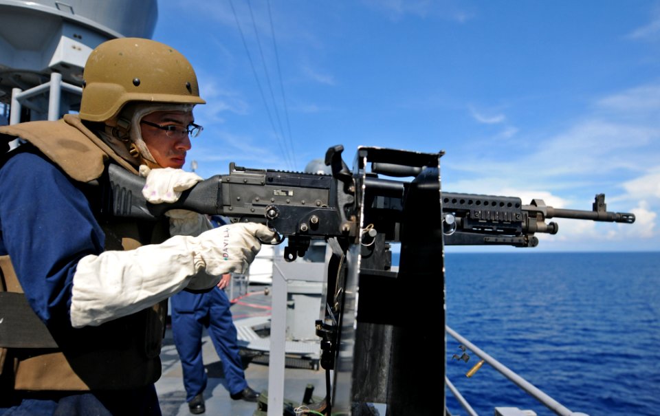 US Navy 111025-N-MW330-557 Quartermaster 3rd Class Ricky Rodriugez fires an M240B machine gun during a live-fire exercise aboard the forward-deploy