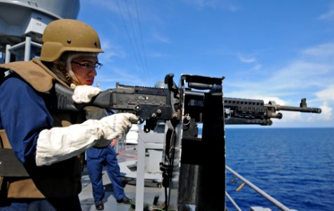 US Navy 111025-N-MW330-557 Quartermaster 3rd Class Ricky Rodriugez fires an M240B machine gun during a live-fire exercise aboard the forward-deploy