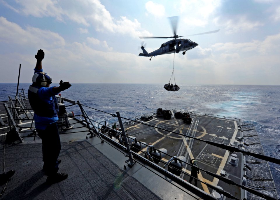 US Navy 111025-N-VH839-016 Seaman Jose Cortez signals an MH-60R Seahawk helicopter assigned to the Raptors of Helicopter Maritime Strike Squadron (