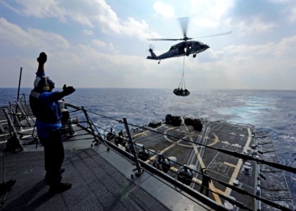US Navy 111025-N-VH839-016 Seaman Jose Cortez signals an MH-60R Seahawk helicopter assigned to the Raptors of Helicopter Maritime Strike Squadron (