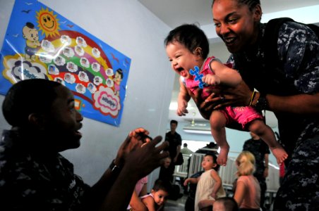 US Navy 111025-N-WW409-286 Sailors assigned to the guided-missile destroyer USS Mustin (DDG 89), play with children at the Pattaya Orphanage