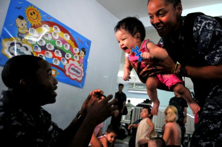 US Navy 111025-N-WW409-286 Sailors assigned to the guided-missile destroyer USS Mustin (DDG 89), play with children at the Pattaya Orphanage photo