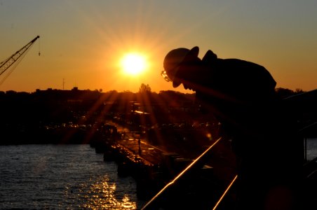 US Navy 111025-N-YX169-035 Boatswain's Mate 1st Class Dewey McKoy watches from the forcastle of amphibious transport dock ship USS Ponce (LPD 15) a