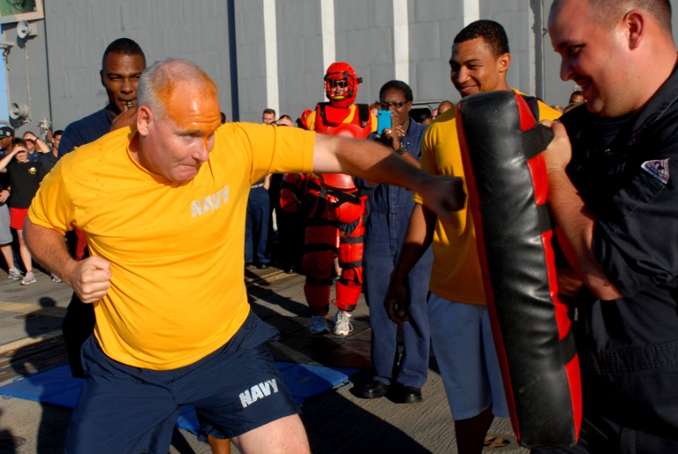US Navy 111022-N-DU438-067 Cmdr. John Gray, the executive officer aboard the guided-missile destroyer USS Gettysburg (CG 64) punches a bag after be