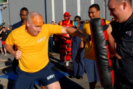 US Navy 111022-N-DU438-067 Cmdr. John Gray, the executive officer aboard the guided-missile destroyer USS Gettysburg (CG 64) punches a bag after be