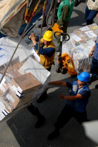 US Navy 111025-N-DU438-197 Sailors aboard the guided-missile cruiser USS Gettysburg (CG 64) guide a pallet of supplies during a replenishment at se