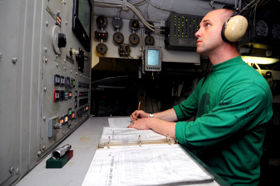US Navy 111022-N-JD217-010 Aviation Boatswain's Mate (Equipment) 3rd Class Matthew J. Boyer records catapult steam pressure during flight operation