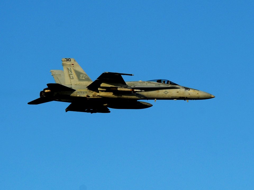 US Navy 111024-N-OY799-722 An F-A-18C Hornet assigned to the Warhawks of Strike Fighter Squadron (VFA) 97 flies over of the Nimitz-class aircraft c