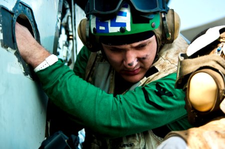 US Navy 111026-N-BT887-072 Aviation Electronics Technician 3rd Class James Prunty troubleshoots the wing of an E-2C Hawkeye from the Golden Hawks o