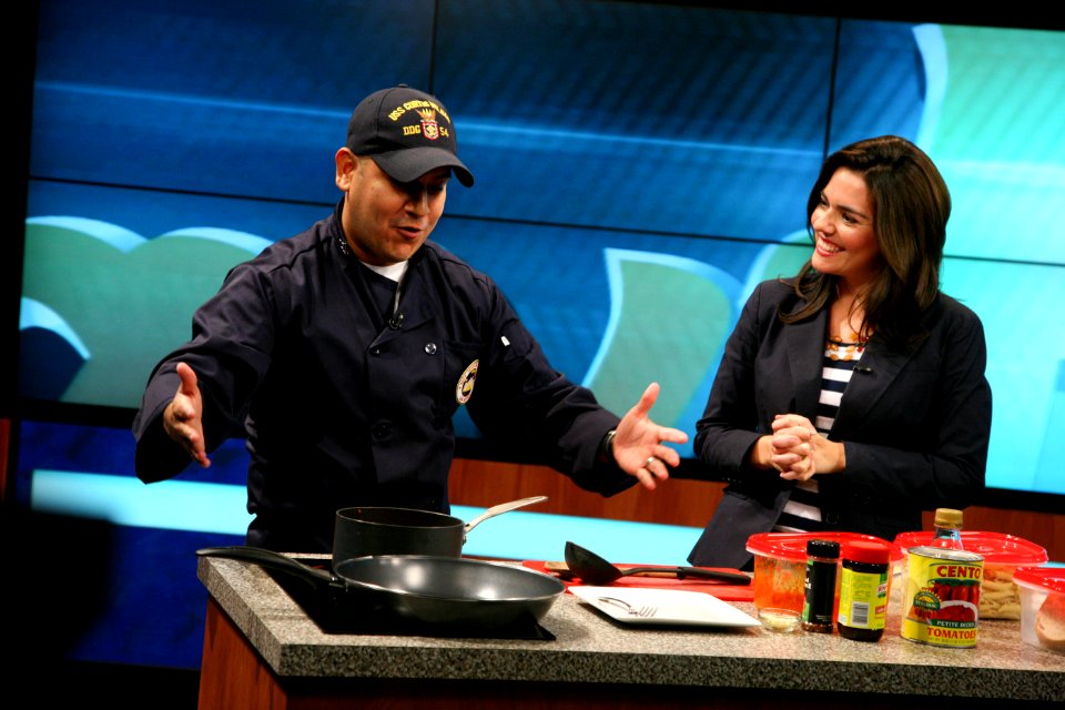 US Navy 111024-N-YM440-021 Culinary Specialist 2nd Class Jorge Vargas, assigned to Navy Recruiting District San Antonio, prepares a meal with KABB