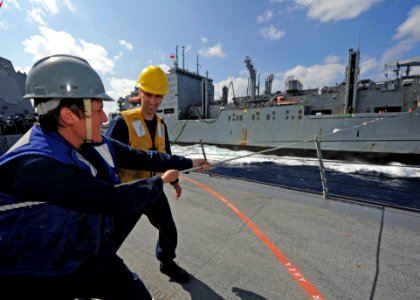 US Navy 111025-N-VH839-129 Gunner's Mate 3rd Class Jennifer Hendricks, from Tampa, Fla., tensions a phone and distance line aboard the guided-missi
