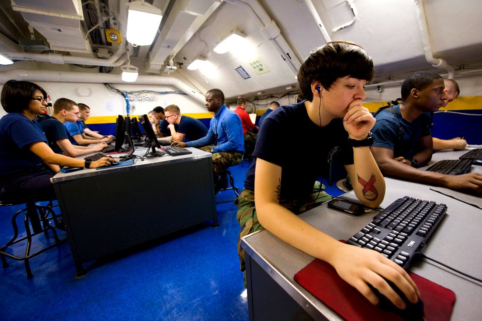 US Navy 111023-N-RJ456-019 Aviation Ordnanceman Airman Mallory Gorse, from Torrington, Conn., uses the computer lab in the ship's library aboard th