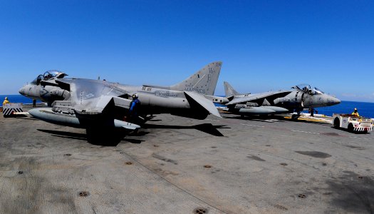 US Navy 111025-N-WJ771-364 Flight deck personnel assigned to the forward-deployed amphibious assault ship USS Essex (LHD 2) reposition AV-8B Harrie