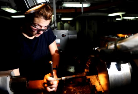 US Navy 111025-N-OY799-199 Machinery Repairman Fireman Recruit Allisen Earls, from Yucaipa, Calif., taps grease caps in the machinery repair shop a