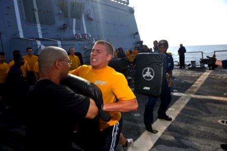 US Navy 111023-N-YZ751-028 Cryptologic Technician (Collection) Seaman Apprentice Scott C. Slaughter hits a target with a baton after being sprayed