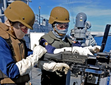 US Navy 111025-N-MW330-756 Armed Forces of the Philippines navy Lt. j.g. Edgardo Sargento Jr., loads rounds into an M240B machine gun