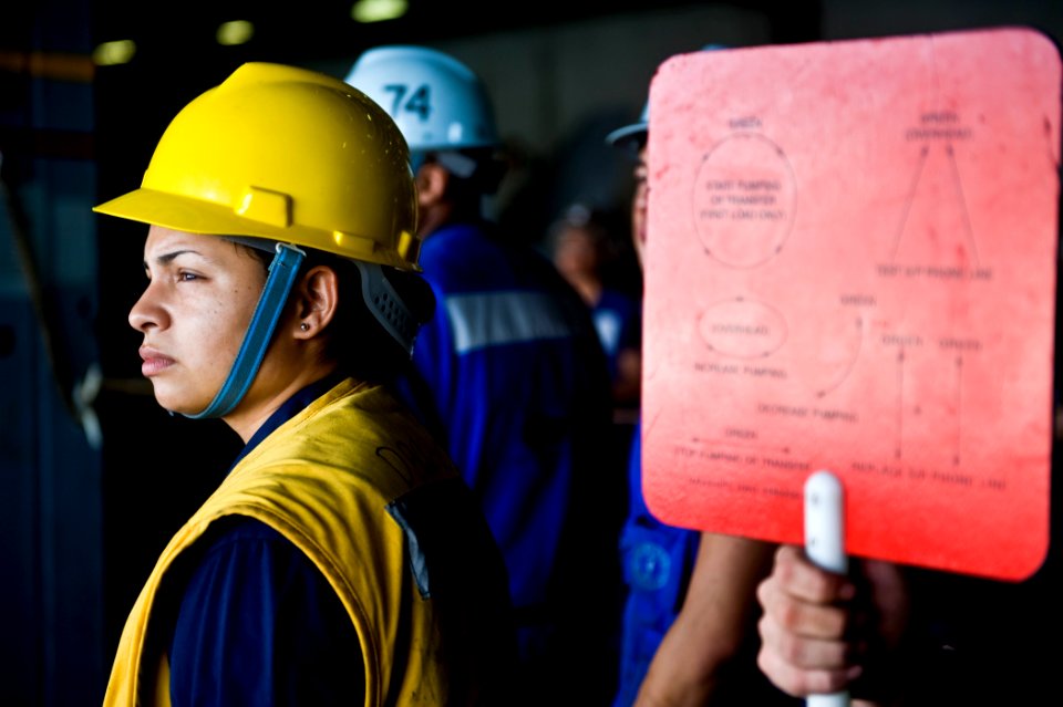 US Navy 111027-N-VN693-454 Boatswain's Mate 2nd Class Madeline Acosta works the sliding padeye during a replenishment at sea aboard the Nimitz-clas