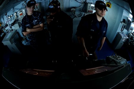 US Navy 111026-N-OY799-125 Sailors stand lee helmsman and helmsman in the bridge aboard the Nimitz-class aircraft carrier USS John C. Stennis (CVN