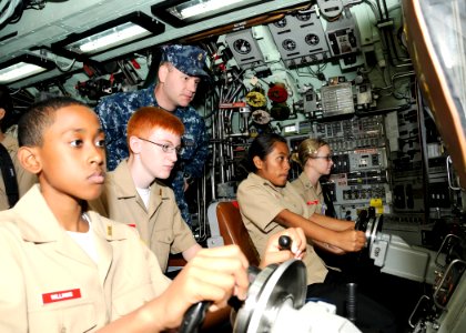 US Navy 111026-N-UK333-046 Chief Electronics Technician Terry Butts explains basic submarine command and control operations to a group of Navy Jun