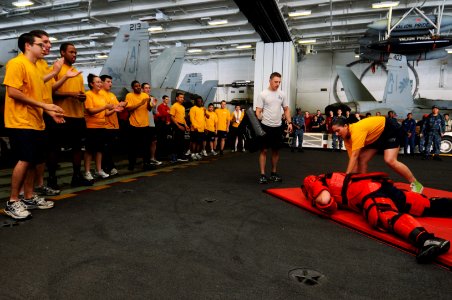 US Navy 111026-N-JD217-059 Operations Specialist 2nd Class Kariyma T. Thomas subdues a threat after being sprayed with oleoresin capsicum (OC) duri