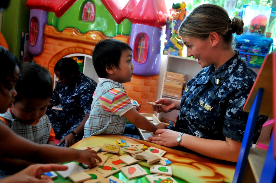US Navy 111025-N-WW409-113 Ensign Margaret Morton, assigned to the guided-missile destroyer USS Mustin (DDG 89), plays with children at the Pattaya