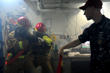 US Navy 111026-N-WA347-085 Sailors enter a smoke filled compartment during a damage control drill aboard the forward deployed amphibious assault sh
