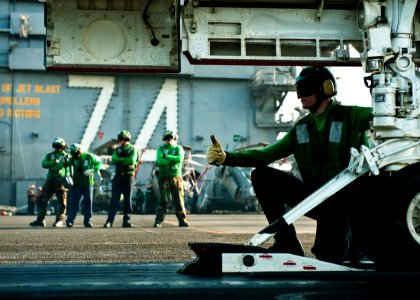 US Navy 111027-N-BT887-483 Aviation Boatswain's Mate (Equipment) Airman Adam Fitzgerald gives the thumbs up to proceed with the launch of an F-A-18