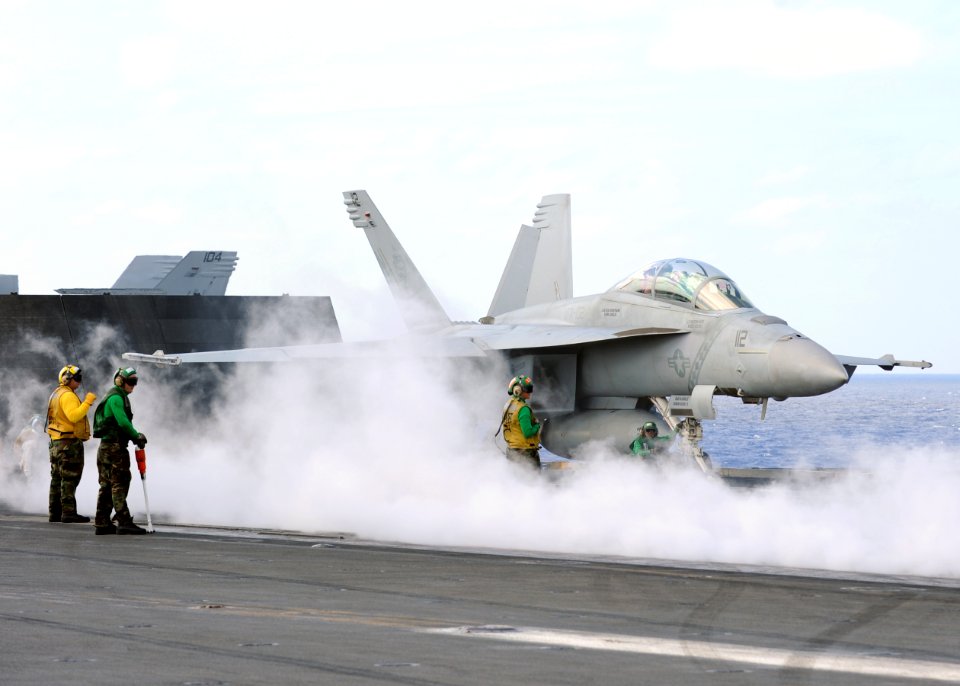 US Navy 111029-N-DS193-008 Sailors prepare an F-A-18F Super Hornet from the Diamondbacks of Strike Fighter Squadron (VFA) 102 for launch aboard the