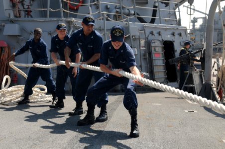US Navy 111028-N-XQ375-097 Sailors heave a line on the foc'sle of the guided-missile destroyer USS Mitscher (DDG 57) photo