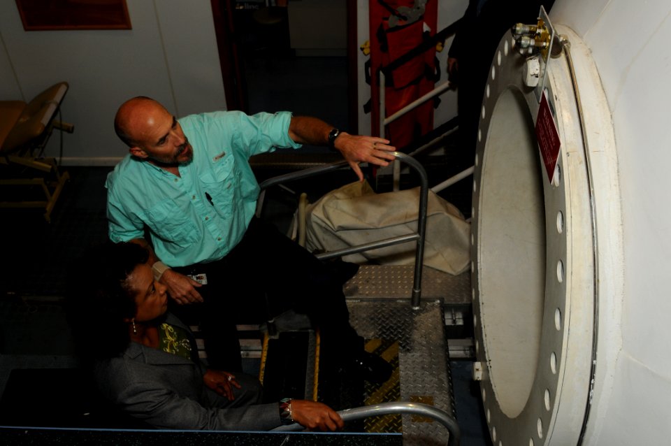 US Navy 111027-N-ZN848-126 Senior Engineer Gary Jacob describes the living conditions of one of the chambers in the Ocean Simulation Facility at Na