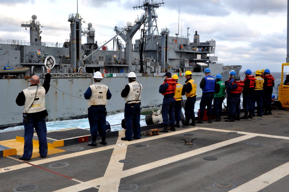 US Navy 111029-N-YX169-410 Chief Warrant Officer 3 William East waves his hardhat aboard the amphibious transport dock USS Ponce (LPD 15) in farew
