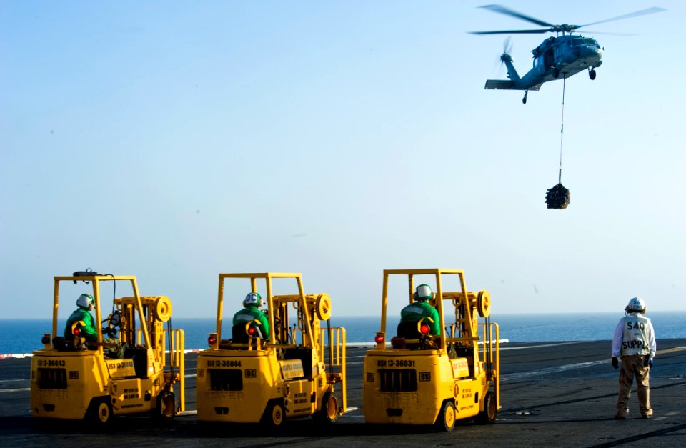 US Navy 111027-N-VN693-168 Sailors await cargo from an MH-60S Sea Hawk helicopter assigned to the Eightballers of Helicopter Sea Combat (HSC) 8 dur