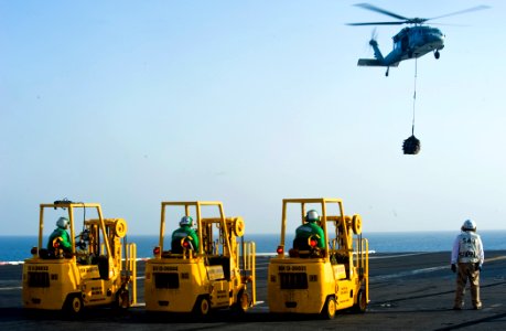 US Navy 111027-N-VN693-168 Sailors await cargo from an MH-60S Sea Hawk helicopter assigned to the Eightballers of Helicopter Sea Combat (HSC) 8 dur