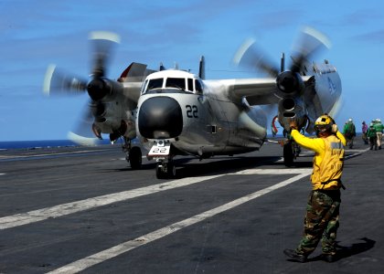 US Navy 111029-N-DS193-014 A Sailor gives hand signals to the pilot of a C-2A Greyhound from the Providers of Fleet Logistics Support Squadron (VR