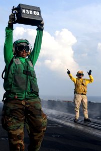 US Navy 111031-N-OY799-103 Aviation Boatswain's Mate (Equipment) Airman Hiyab Tilahun confirms a weight board with an fixed-wing aircraft while Chi