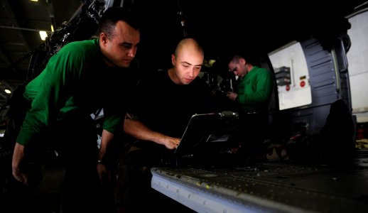 US Navy 111030-N-OY799-213 Sailors review diagrams in hangar bay two aboard the Nimitz-class aircraft carrier USS John C. Stennis (CVN 74)