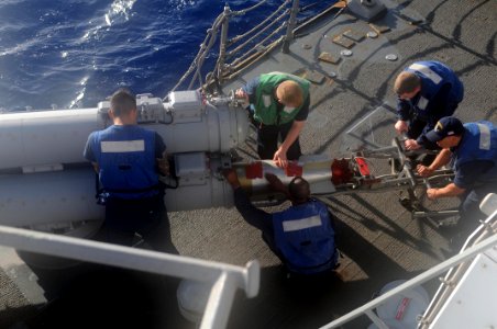 US Navy 111029-N-IO627-058 Sailors load a MK-46 torpedo aboard the Arleigh Burke-class guided-missile destroyer USS Lassen (DDG 82) photo