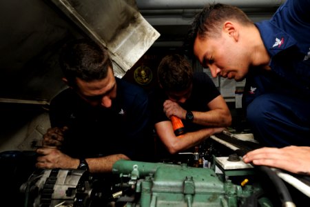 US Navy 111028-N-XE109-044 Sailors troubleshoot a tractor fly wheel aboard the aircraft carrier USS George H.W. Bush (CVN 77)