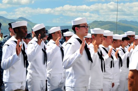 US Navy 111031-N-KM175-058 Sailors take the oath of allegiance during a naturalization ceremony aboard the forward-deployed amphibious assault ship