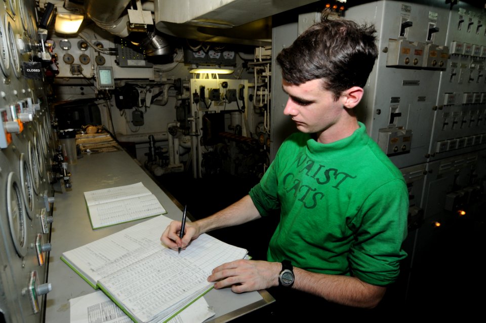 US Navy 111028-N-TU894-005 Aviation Boatswain's Mate (Equipment) Airman Jamison T. Joiner records readings during steam watch aboard the aircraft c