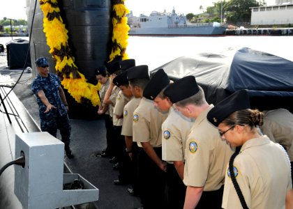 US Navy 111026-N-UK333-010 Electronics Technician 1st Class Edgar Alvarez explains topside operations of the Los Angeles-class attack submarine USS