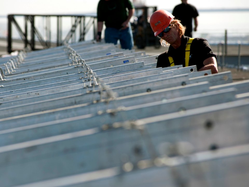 US Navy 111102-N-DR144-300 A civilian contractor installs bleachers on the flight deck as workers build a basketball arena aboard the Nimitz-class
