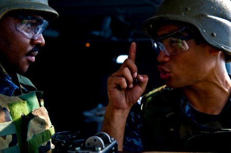 US Navy 111028-N-VN693-182 Hospital Corpsman 2nd Class Robert Carroll receives instruction to fire one shot from a .50 caliber machine gun from Avi