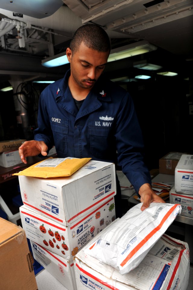 US Navy 111029-N-YZ751-187 Logistics Specialist 2nd Class David Gomez sorts incoming mail on the mess decks aboard the guided-missile destroyer USS