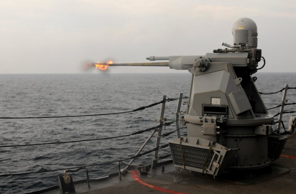 US Navy 111101-N-XQ375-405 The MK 38 25mm machine gun aboard the guided-missile destroyer USS Mitscher (DDG 57)fires during a gunnery exercise
